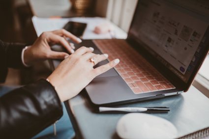 laptop lifestyle event planner using a laptop to plain their retreat itinerary