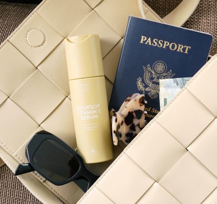 retreat packing list a purse with passport, sunglasses, and sunscreen
